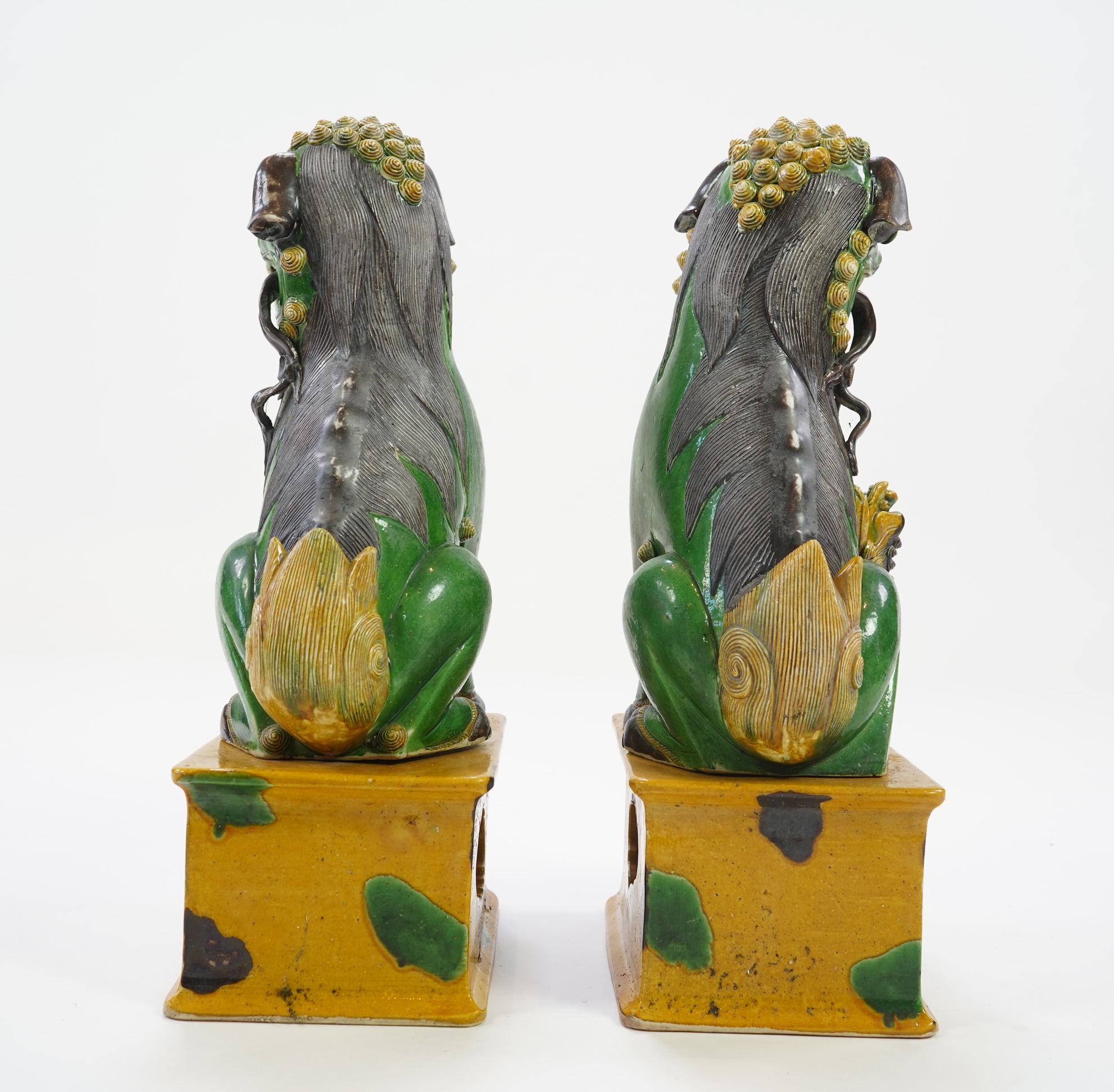 A pair of large Chinese sancai-glazed biscuit figures of Buddhist temple lions, 19th century